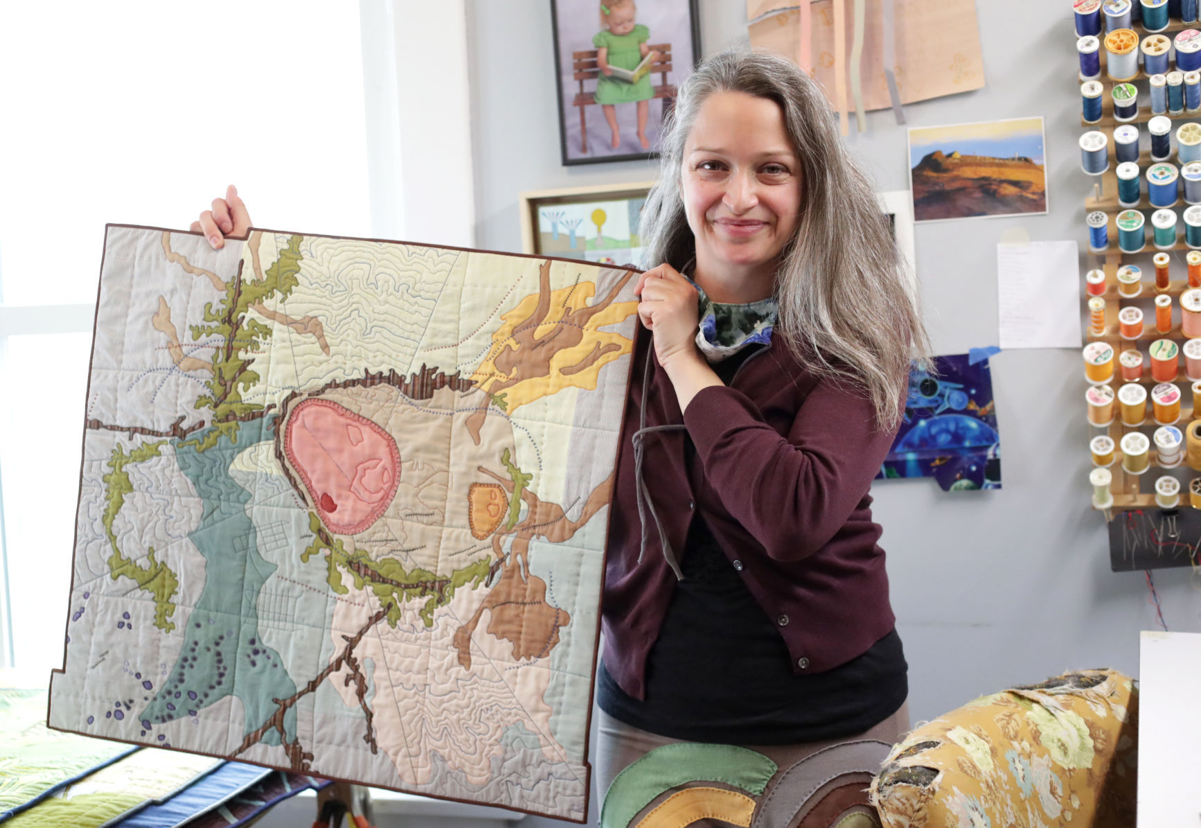 Textile artist Leah Evans showing a quilted piece